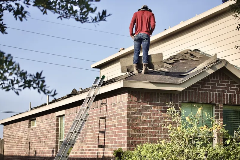Professional roofer working on a residential roof in Pleasant Run
